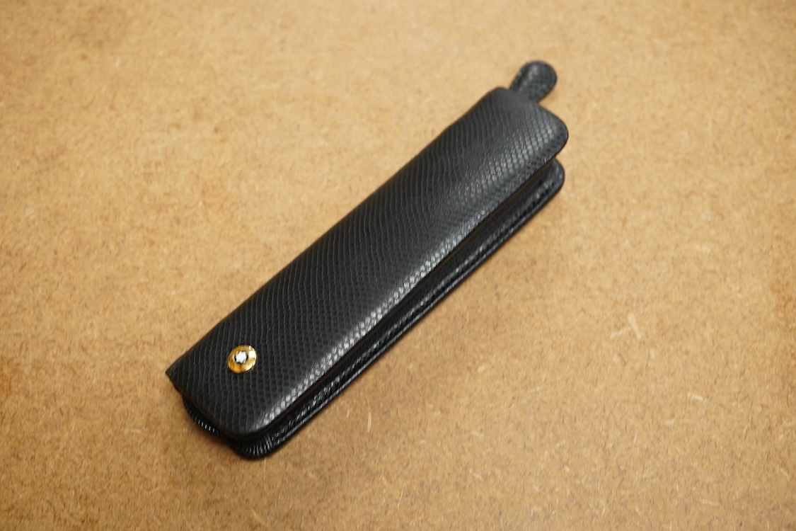 A leather cased Mont Blanc pen with retractable nib and decorative jewelled clip, 11cm long
